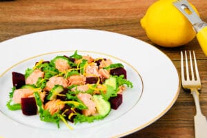 salad with salmon, greens, and citrus zest